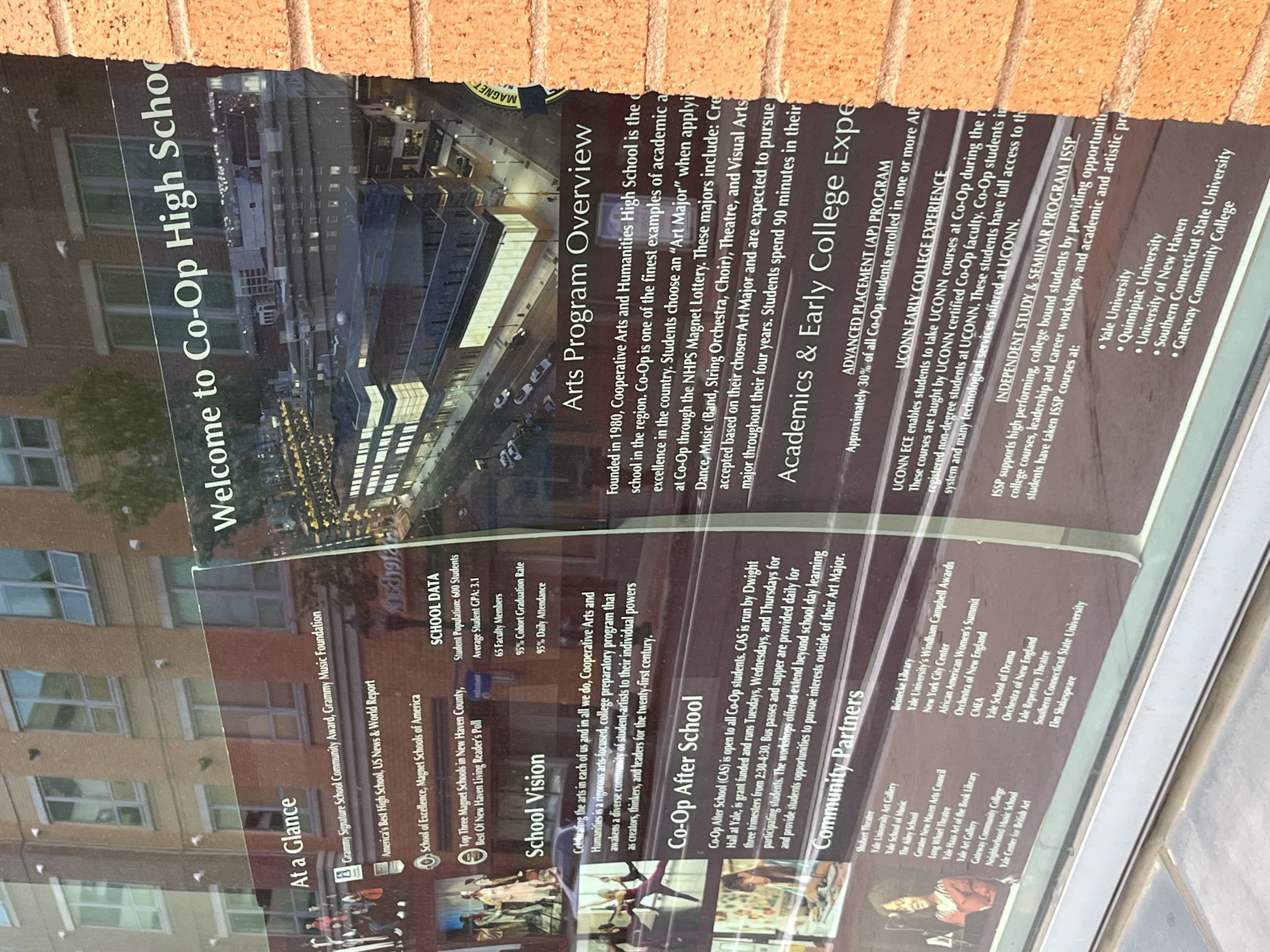 Posters in Co-op High School window which display the school's unique curriculum and facilities.