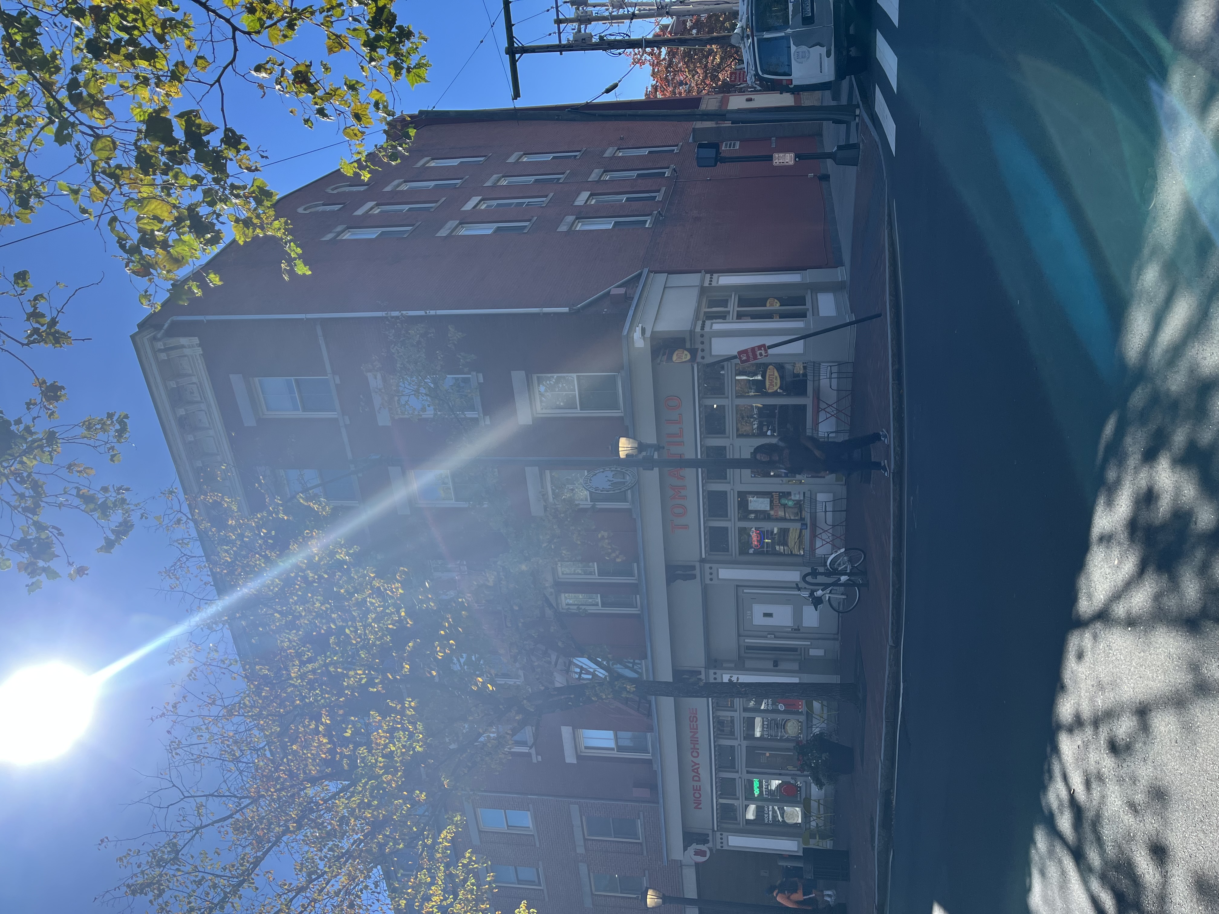 Current view of 316-320 Elm Street from the Elm/Park intersection. Nice Day Chinese and Tomatillo occupy the remodeled commercial ground floor, while the brick masonry, stone window trim, and bracketed cornice of the nineteenth-century upper stories remain clearly visible.