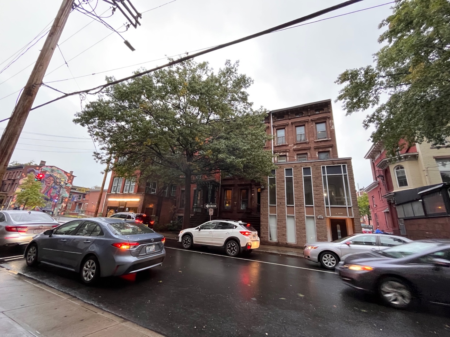 This image captures 281 Crown St in the transition between Yale student life and New Haven's more public downtown. On the left, we see a mural from the Asian American Cultural Center... To the right, we see the beginnings of Geronimo's Tequila Bar as we transition into the more commercial and social downtown.