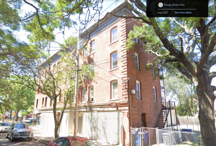 This image, taken from Google Earth, shows the view of the building from its cross street, Carlisle Street. We notice a fire escape, as well as the appearance of white, slated walls on the wall closest to the viewer. In the right corner, we can also see the balconies on each floor.